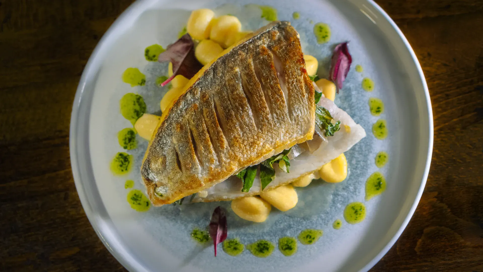 Pan-fried sea bream with herb oil and potato purée